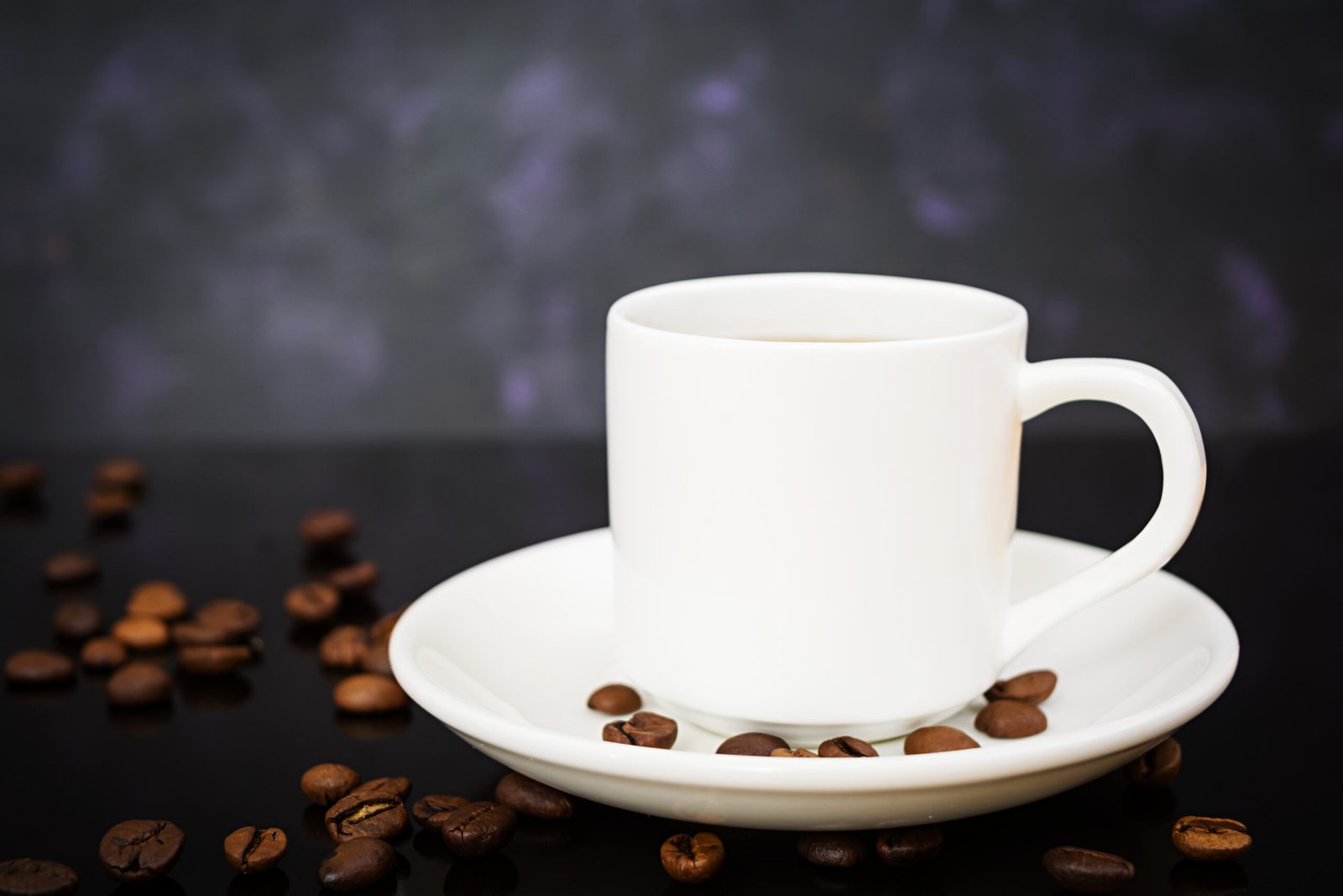 cup of coffee, with beans scattered around