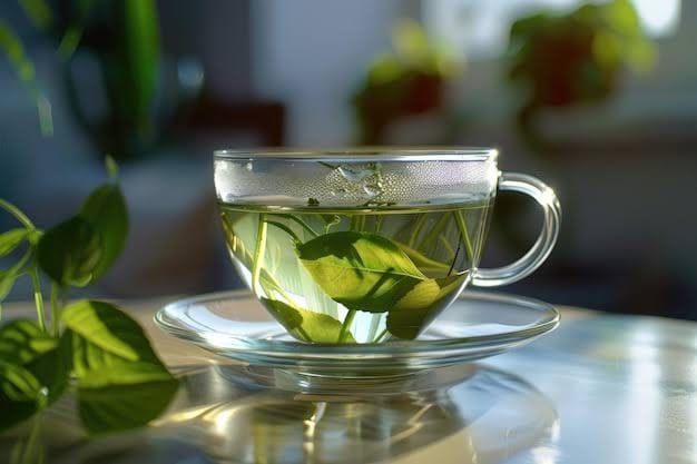 A glass of green tea with tea leaves inside - Amount Caffeine in Green Tea