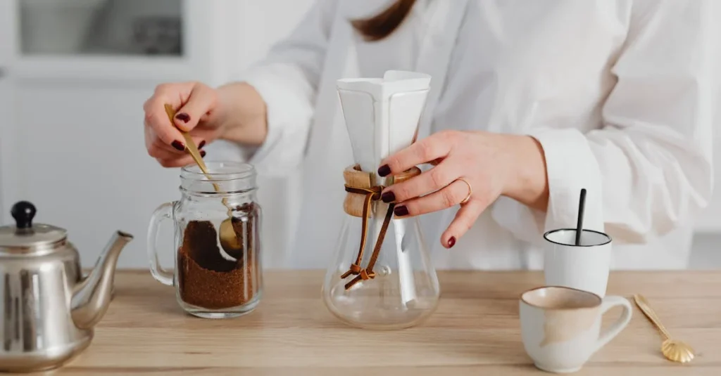 person preparing coffee using Chemex, prompting the question French press vs Chemex?