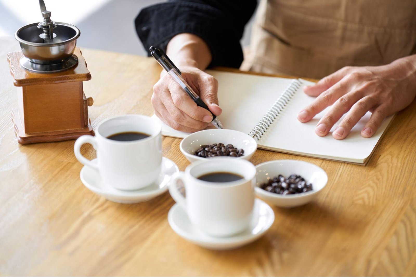 person writing notes while having coffee