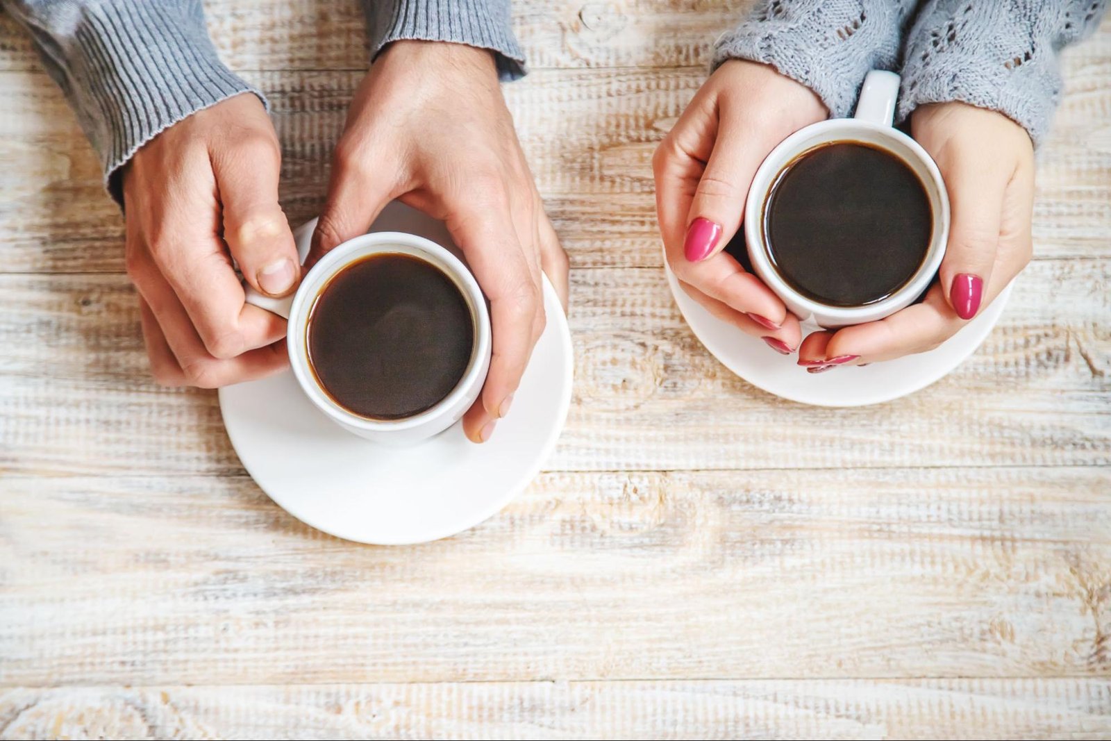 people holding cups of coffee